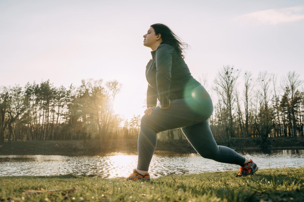 Woman doing yoga at sunrise