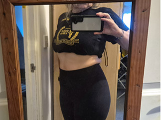 Women showing weight loss in mirror.