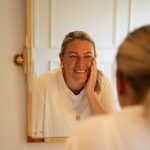 Woman looking at self in mirror