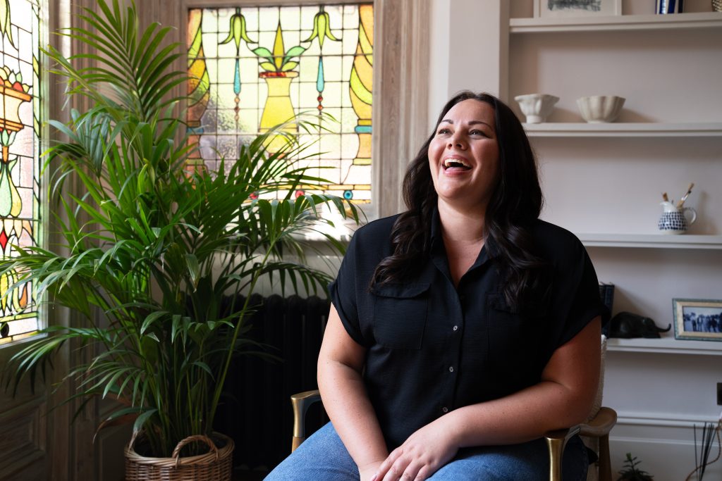 Woman sat in chair, laughing