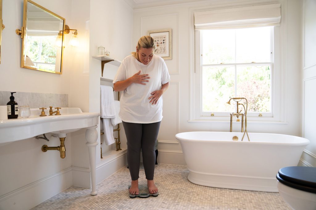 Woman on scales in bathroom