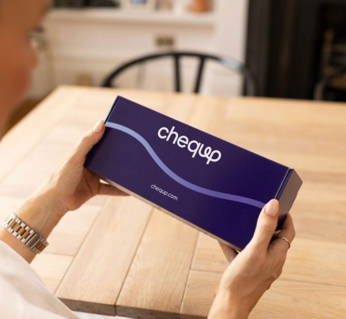 A lady holding the CheqUp medication box