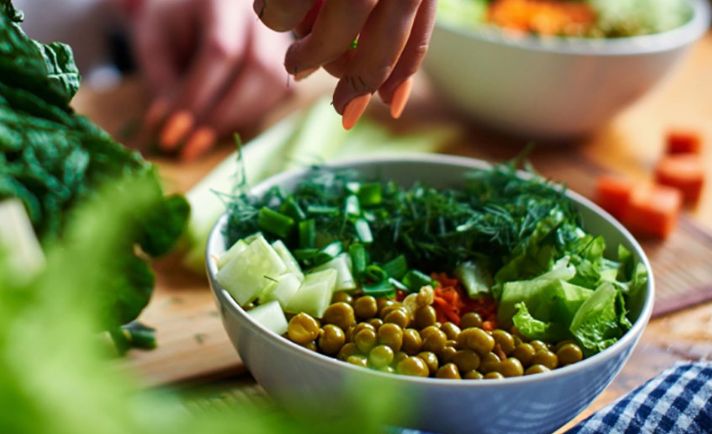 A close up of a salad being prepared