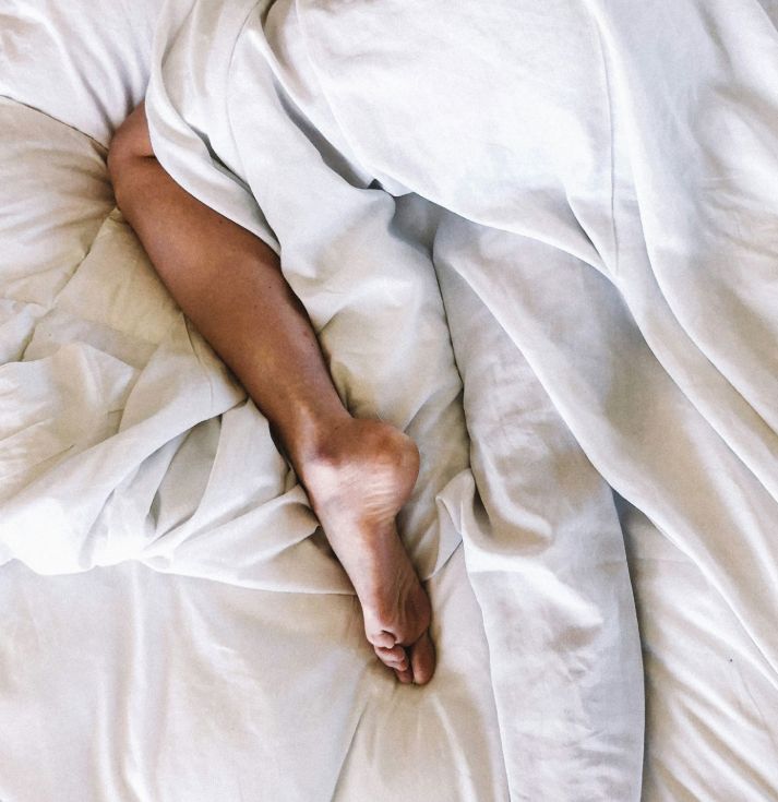 A leg wrapped in bed covers