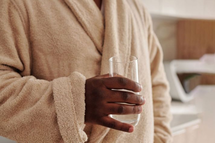 A person holding a glass of water