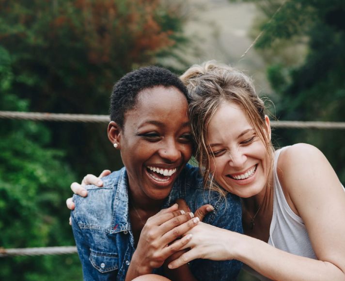 Two ladies laughing together
