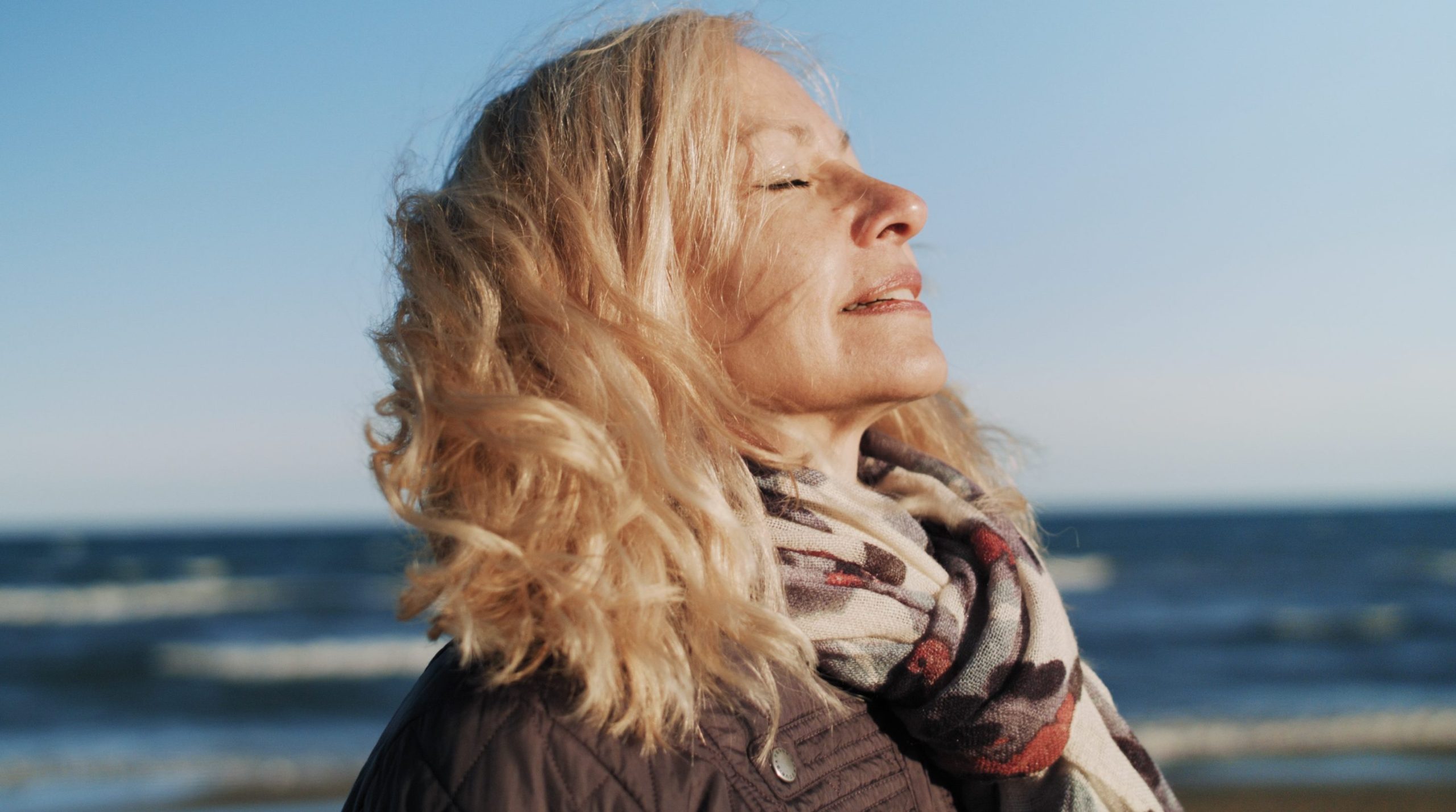 Woman relaxing on the beach, taking a moment for herself